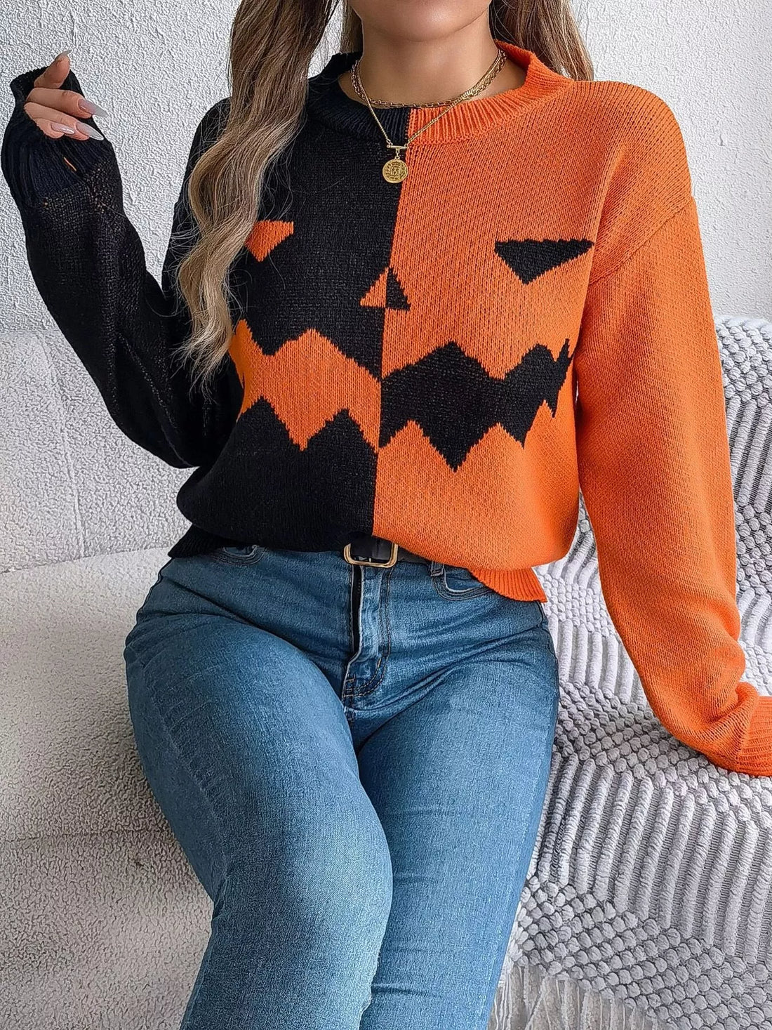 Two-tone pumpkin face graphic sweater, orange/black zip-front knit, long sleeves