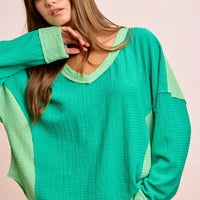 Textured jersey color block top in emerald green with light green cut-edge cuffs