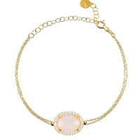 Gold bracelet with oval rose quartz gemstone and pavé border