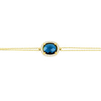 Gold oval blue gemstone bracelet close-up on chain
