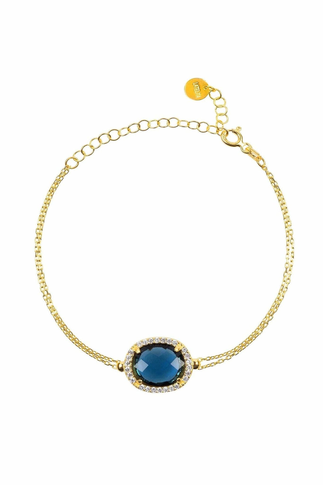 Gold chain bracelet with oval blue gemstone center