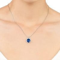 Silver chain necklace with small oval blue gemstone pendant