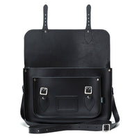 Black leather satchel with two top tabs, front pocket panel, and crossbody strap.