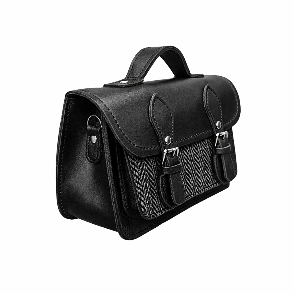 Black leather and tweed micro satchel, side view with double buckle closures and top handle