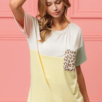 Color-block crew-neck top with leopard front pocket; white and mint sleeves, yellow body