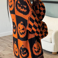 Orange and black pumpkin-check knit sweater with round neck and long sleeves