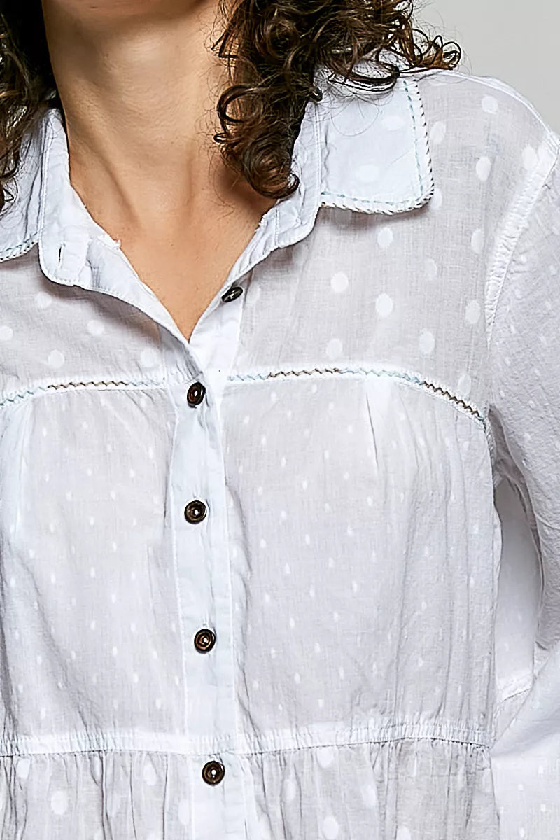 Off-white textured shirt neckline with button placket and tonal dots
