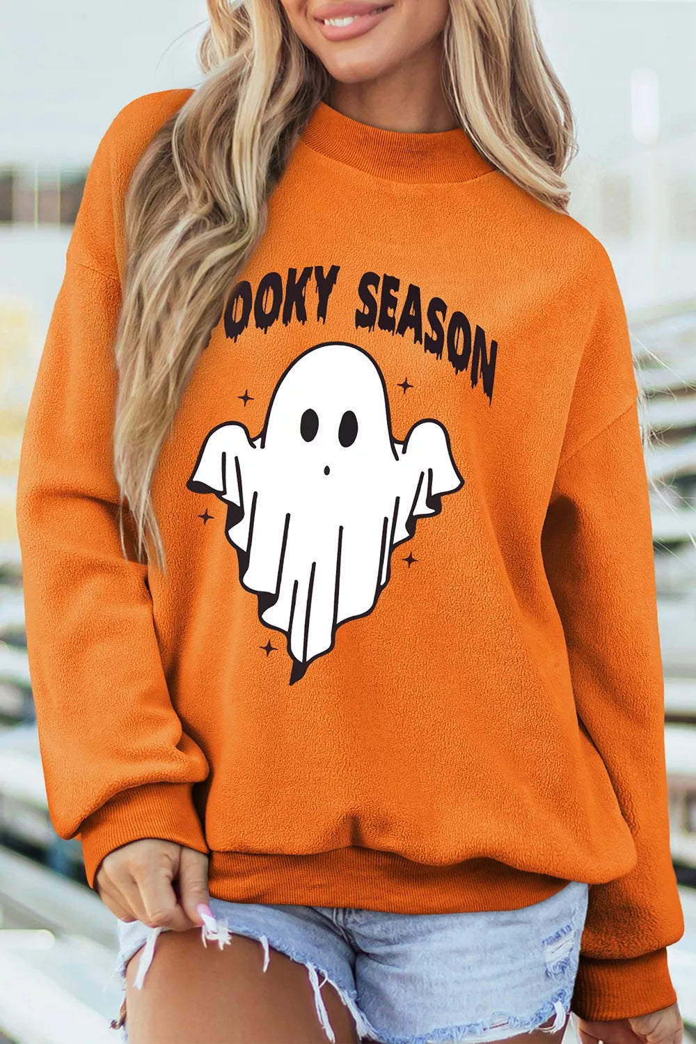 Orange mock neck sweatshirt with &