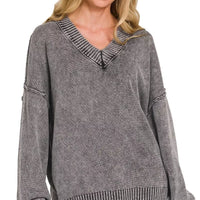 Washed dark gray oversized sweater with deep V-neck and ribbed cuffs