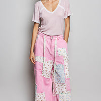 Baby pink textured V-neck T-shirt with white lace-trimmed neckline and short sleeves