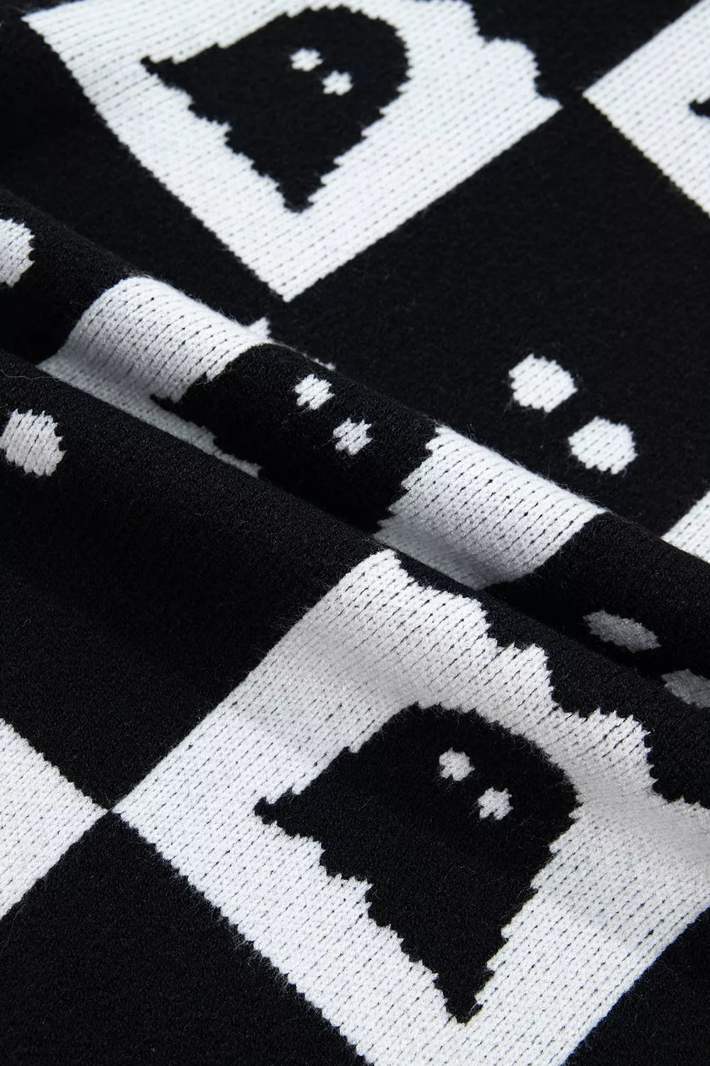 Black and white checkerboard ghost sweater with long ribbed sleeves