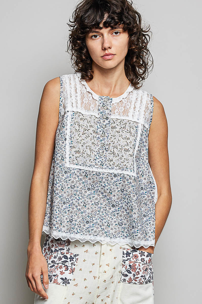 Off-white sleeveless woven lace round-neck top with blue floral print and scalloped hem