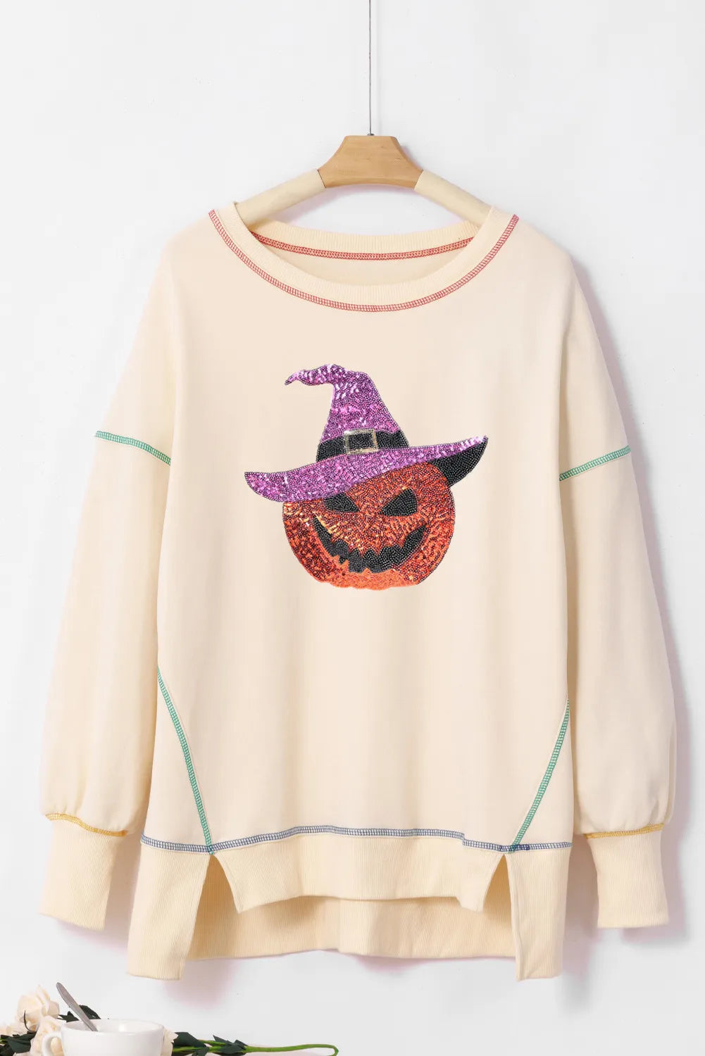 Ivory sequin pumpkin sweatshirt with striped contrast trim and relaxed crew neck