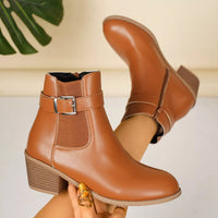 Brown point-toe block heel ankle boot with front buckle strap and side seam
