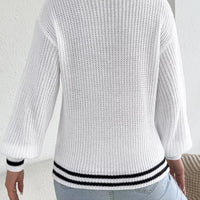 White cutout cable knit sweater, back view with ribbed hem and cuffs in black trim