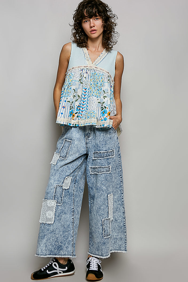 Light blue sheer floral V-neck lace-trim tank with tiered hem and eyelet texture.