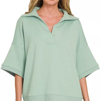 Dusty green collared short-sleeve pullover top with V-neck placket