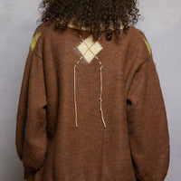 Back view of mocha argyle mohair V-neck sweater with diamond motif and exposed contrast stitch detail