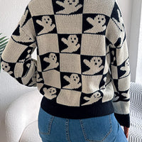 Back view: black and cream checkerboard Halloween sweater with ghost face pattern