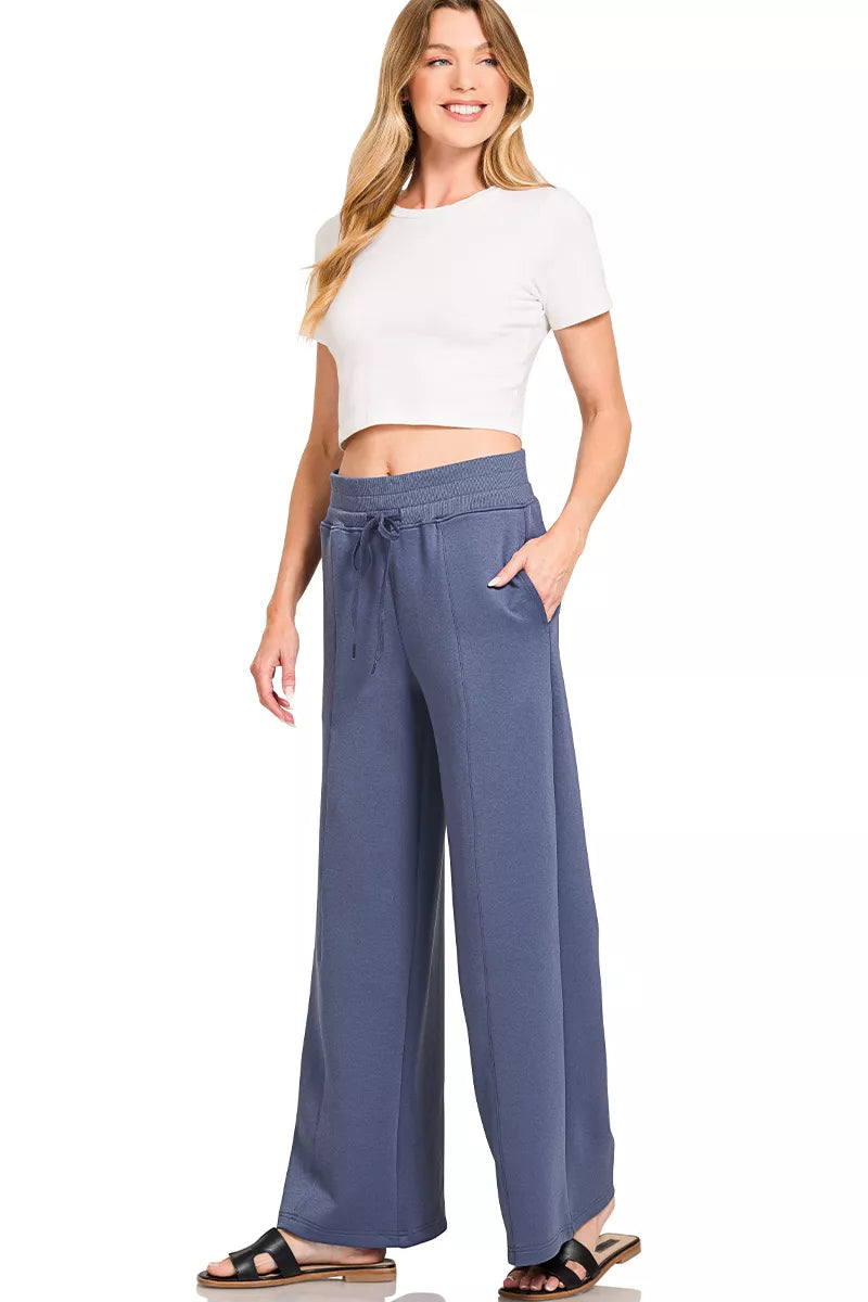 Blue indigo drawstring waist wide-leg center-seam pants with off-white cropped top