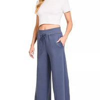 Blue indigo drawstring waist wide-leg center-seam pants with off-white cropped top