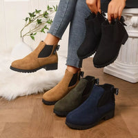 Tan suede ankle boots with round toe, block heel, and jeweled bow detail