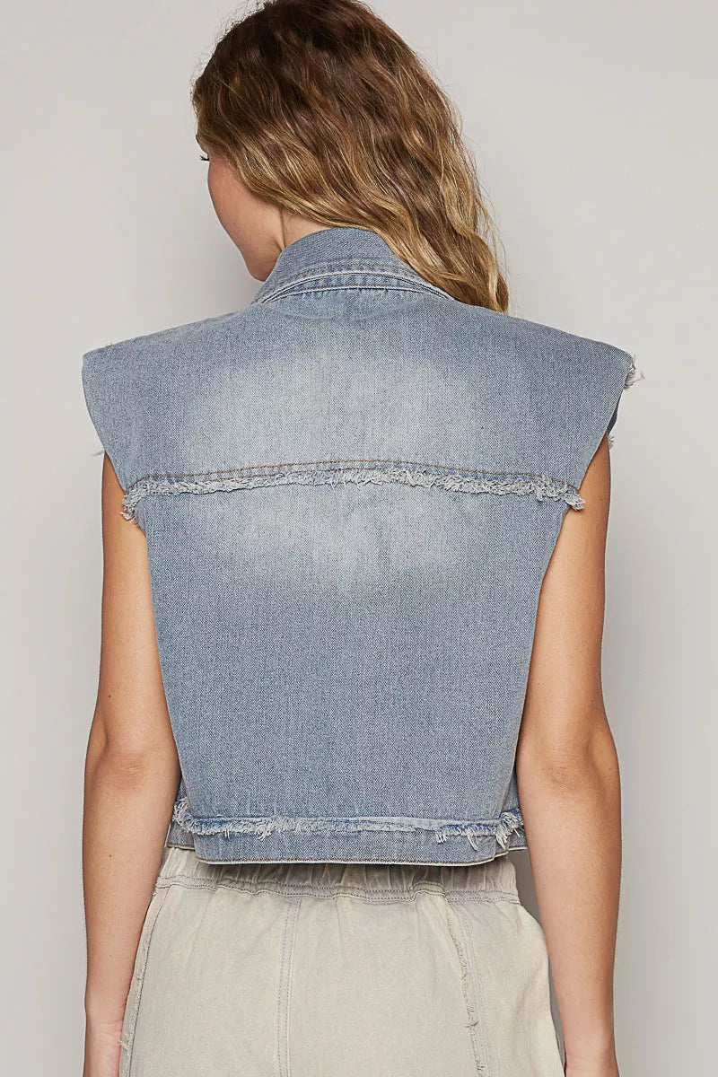 Back view of light wash denim sleeveless vest with raw hem and seam detailing