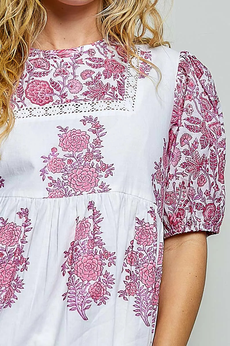 Close-up of ivory and pink floral hand-block print woven blouse front