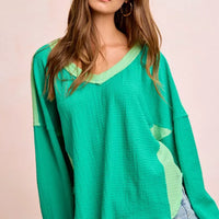 Textured jersey color block top, emerald green with light green panel detail at side seam