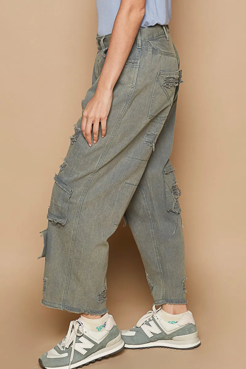 Distressed wide-leg denim pants with raw hem, layered cargo pockets