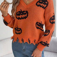 Orange V-neck pumpkin sweater with black jack-o’-lantern print and distressed frayed hem
