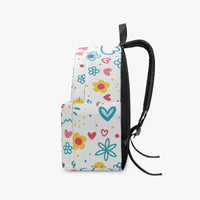 Small kids canvas backpack with colorful doodle print, front pocket, and black side strap