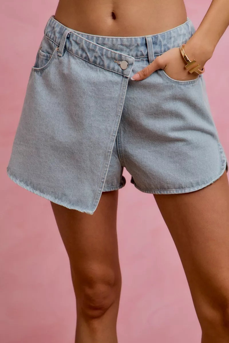 Light blue washed denim wrap skort with button closure and side pockets