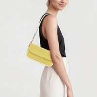 Yellow leather mini shoulder bag with flap front and gold chain strap on shoulder.