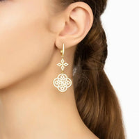 Gold Celtic knot clover drop earring worn on the ear