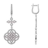 Silver drop earrings featuring cross-shaped charm and clover medallion detail