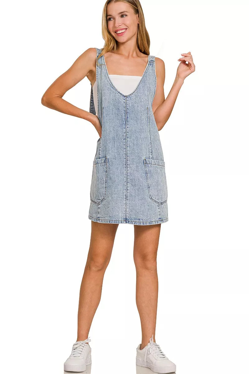 Light wash denim overall dress with adjustable straps and two front pockets