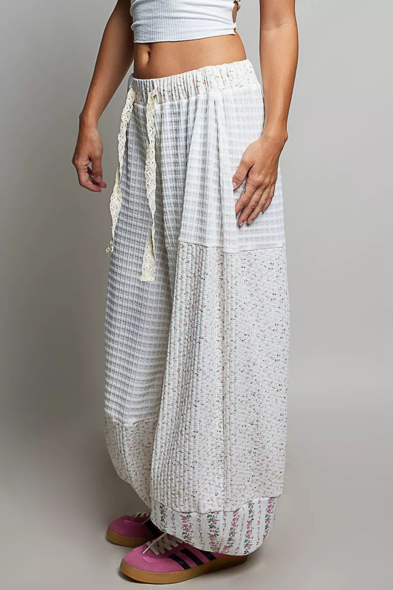 Ivory patchwork knit wide-leg pants with elastic waist and vertical textured panels