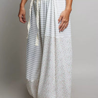 Ivory patchwork knit wide-leg pants with elastic waist and vertical textured panels