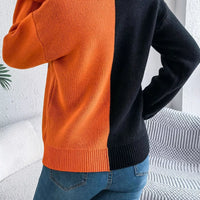 Two-tone knit sweater with pumpkin face graphic, back view in orange and black