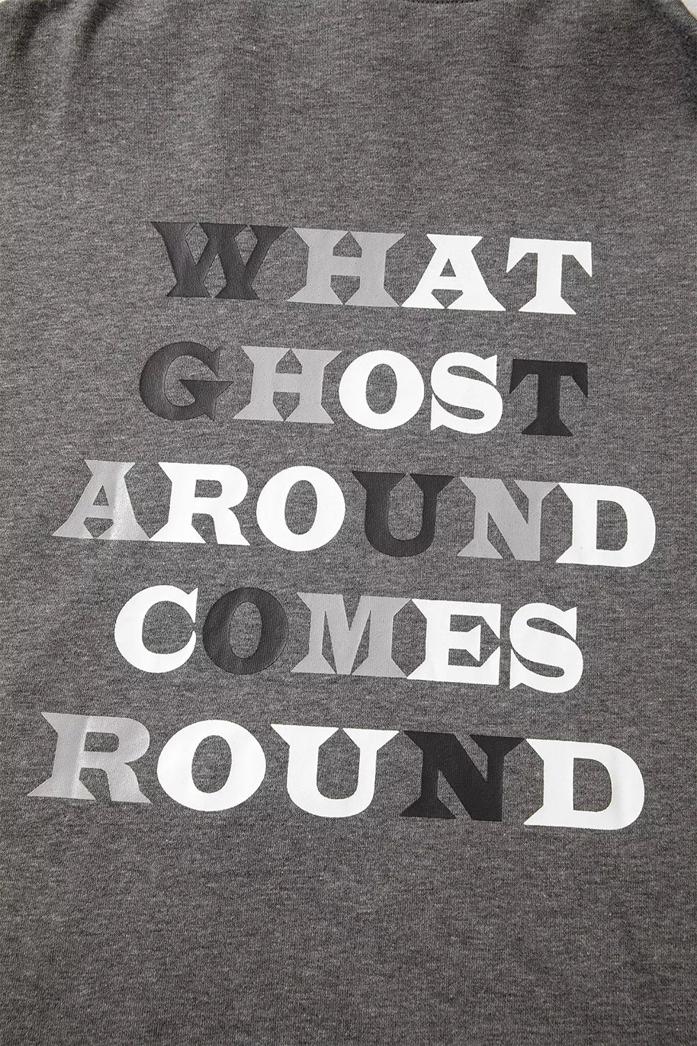 Dark gray hoodie chest graphic text "WHAT GHOST AROUND COMES ROUND"