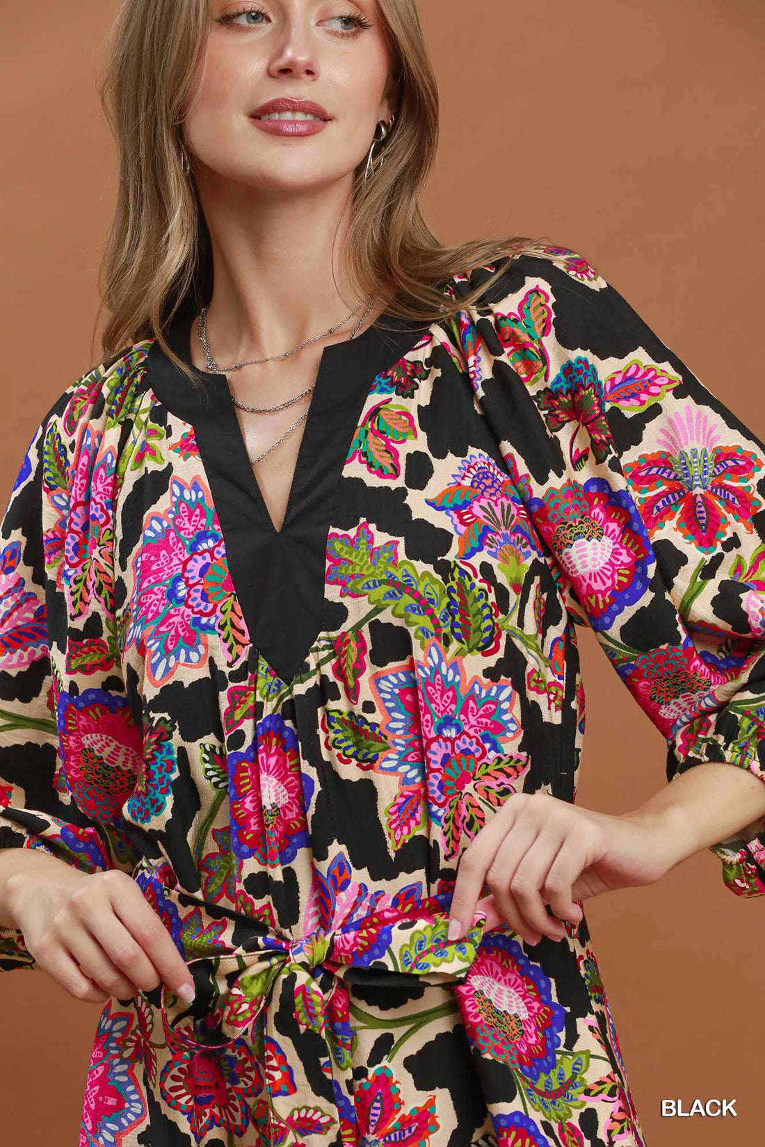 Black abstract print belted midi dress detail: V-neck with colorful pattern and gathered waist