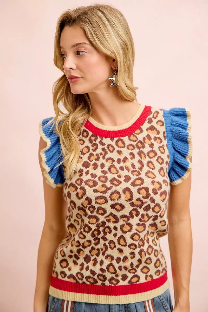 Leopard print knit top featuring blue ruffled cap sleeves and red neckline
