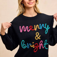 Black pullover sweater with multicolor tinsel "Merry & Bright" graphic on front