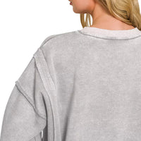 Back view of gray acid-washed fleece pullover with contrast shoulder seam