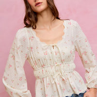 White floral clip-dot blouse with scalloped lace neckline, ruched bodice, and puff sleeves