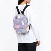 Kids purple kitten-print backpack worn with black shoulder straps from behind