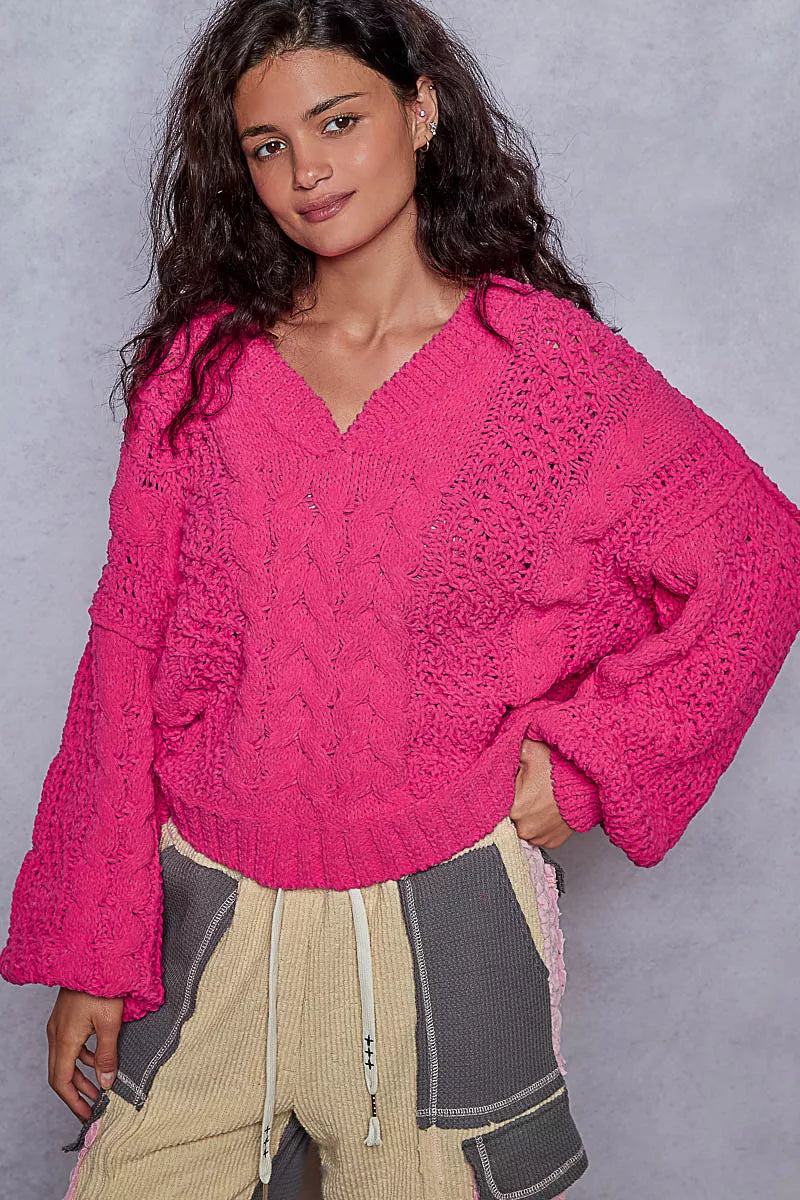 Fuchsia cable-knit cropped V-neck sweater with wide ribbed cuffs and textured knit detail
