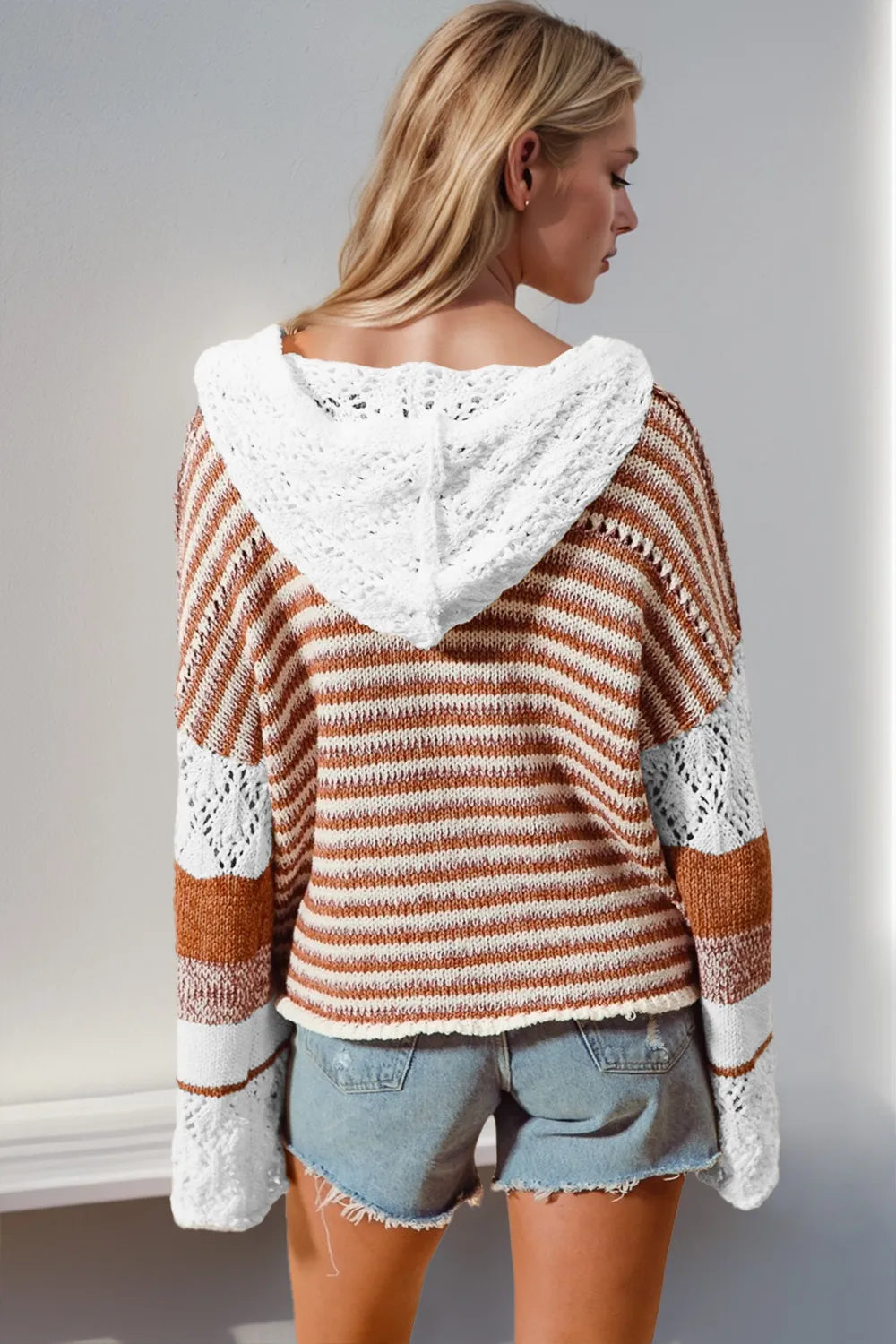 Camel and white striped hooded knit sweater with openwork sleeves, back view