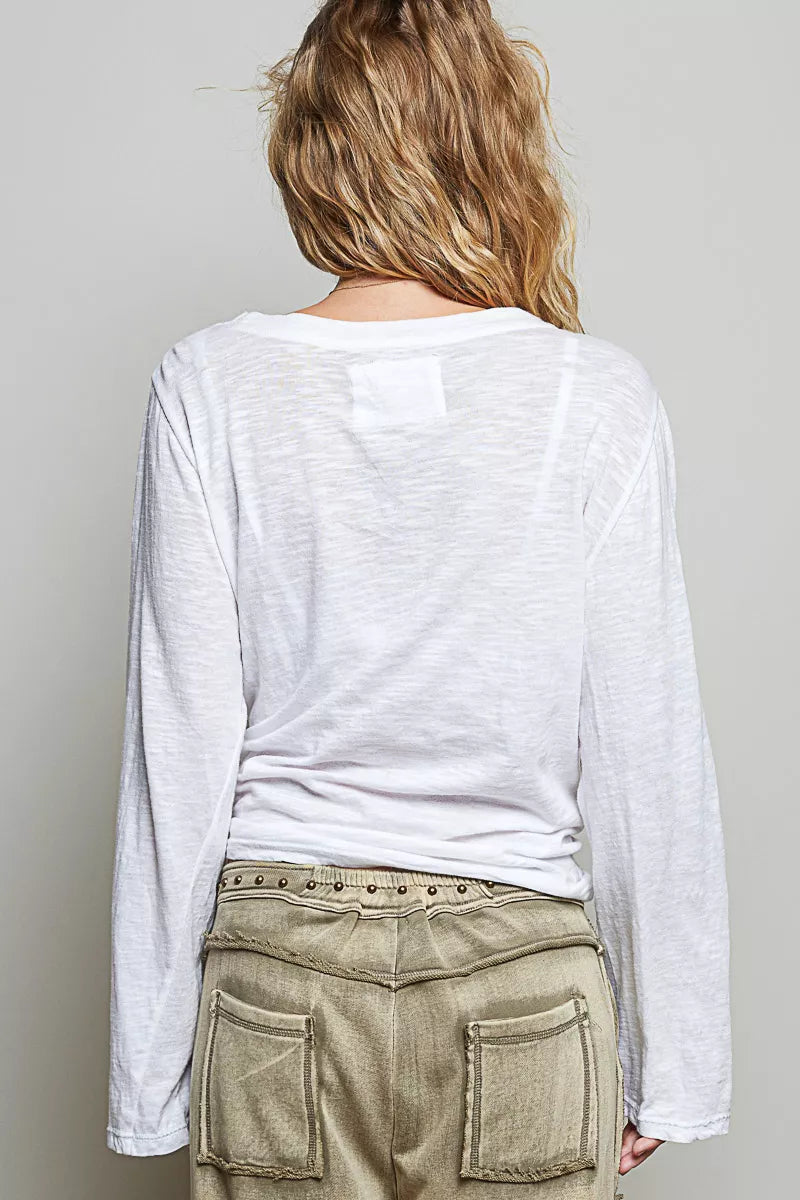 Off white long-sleeve knit top from back view with center yoke patch.